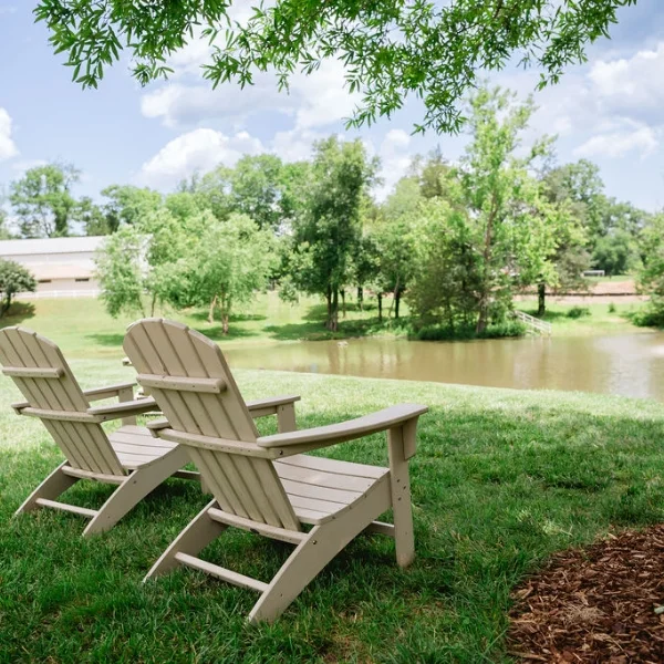 Adirondack chairs in front of lake