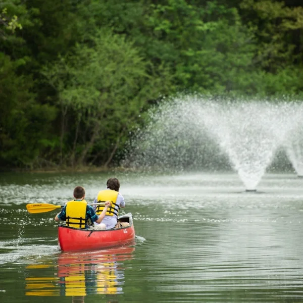students canoeing in lake